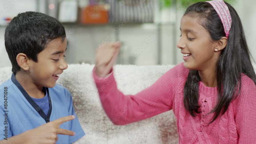 Brother and sister playing rock, paper, scissors at home 素材庫影片 Adobe