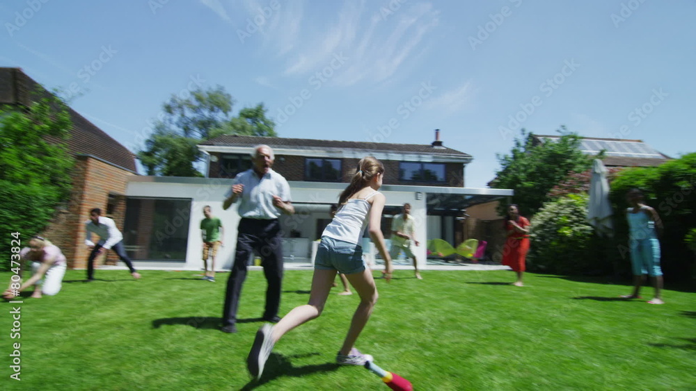 Family & friends of many generations playing sports in the garden on a sunny day Family & friends of many generations playing sports in the garden on a sunny day