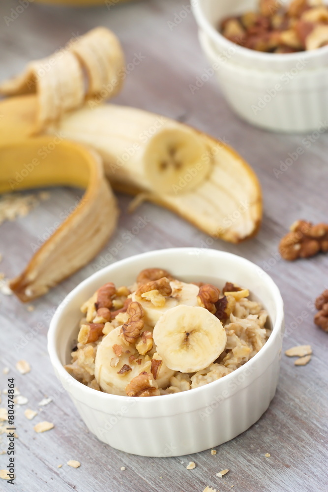 Oatmeal with banana, honey and walnuts for breakfast Oatmeal with banana, honey and walnuts for breakfast