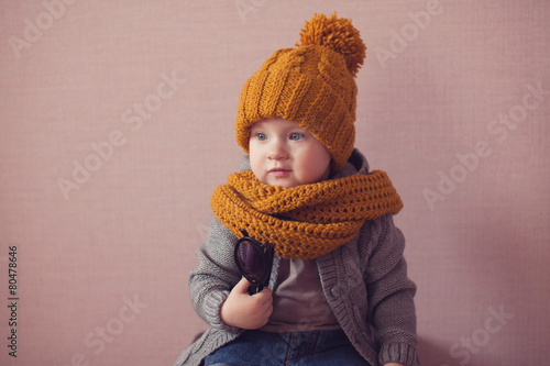 cute kid in knitted mustard color hat