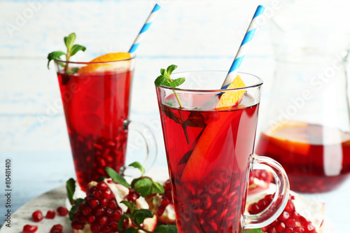 Pomegranate drink in glasses with mint and slices of orange