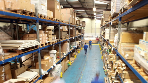 Time lapse of male workers in warehouse preparing goods for dispatch photo