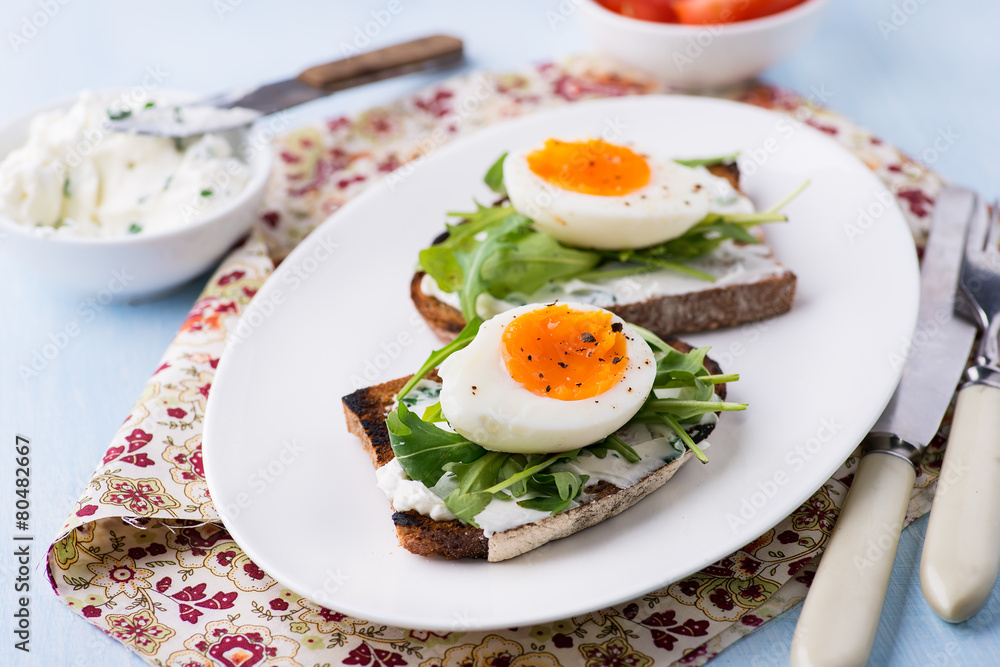 Rye toast sandwiches with egg and soft cheese