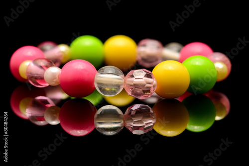 A colorful beaded bracelet isolated on black background