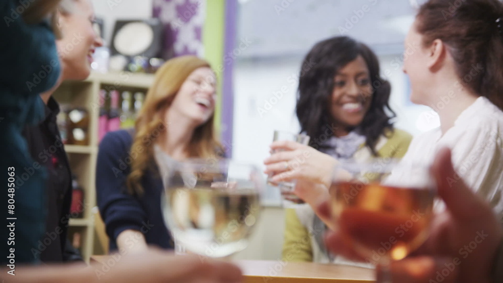 Happy group of female friends chatting together in a cafe Happy group of female friends chatting together in a cafe