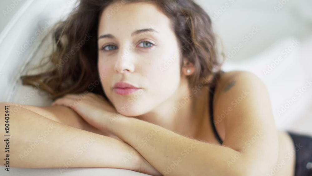 Beautiful brunette model wearing lingerie relaxing in her boudoir. Beautiful brunette model wearing lingerie relaxing in her boudoir.