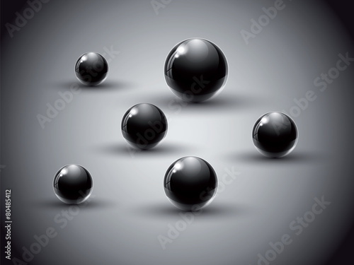 Black glass balls on abstract background.