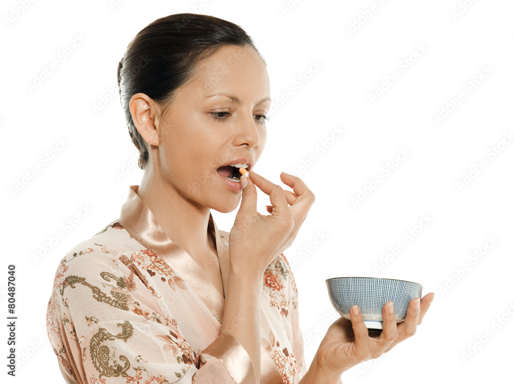 Portrait of beautiful Asian woman taking pill Portrait of beautiful Asian woman taking pill