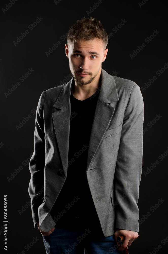Fototapeta premium portrait of young negligent man on dark background
