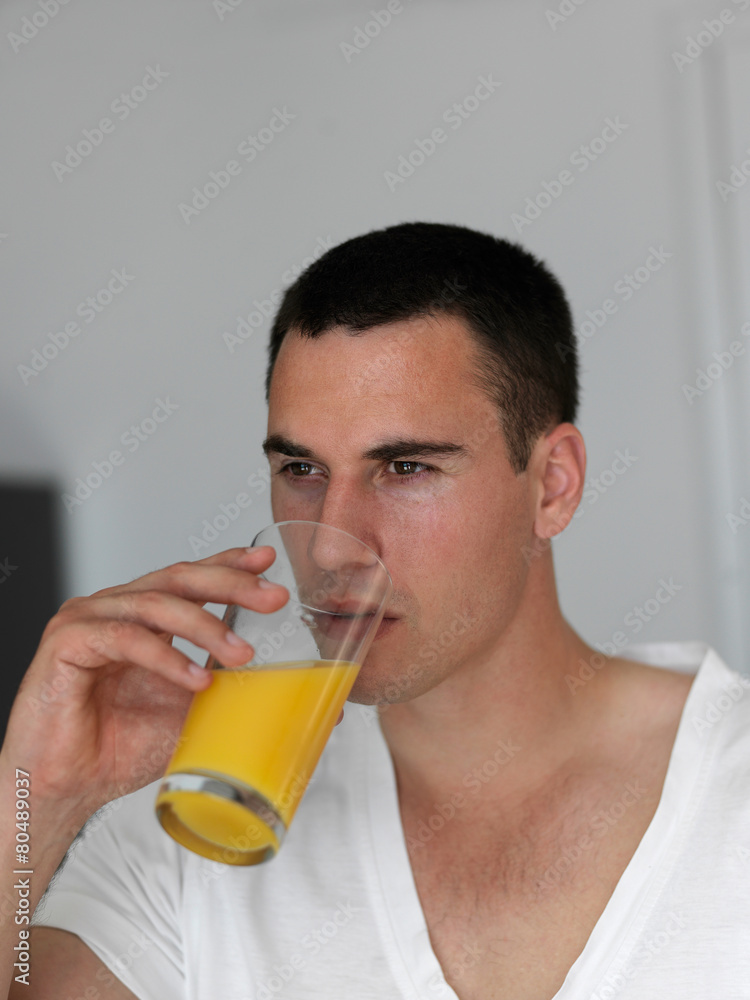 man having orange juice