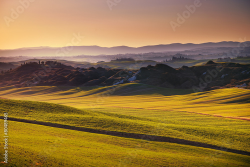 Crete senesi, rolling hills on sunset. Rural landscape near Sien