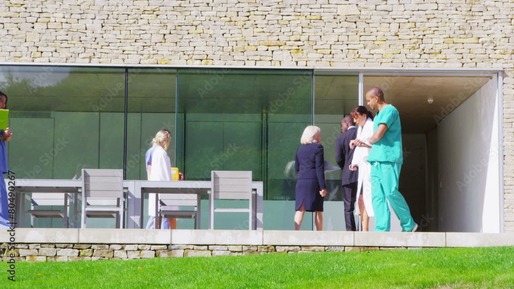 Caring medical worker helps a patient to walk on crutches Caring medical worker helps a patient to walk on crutches