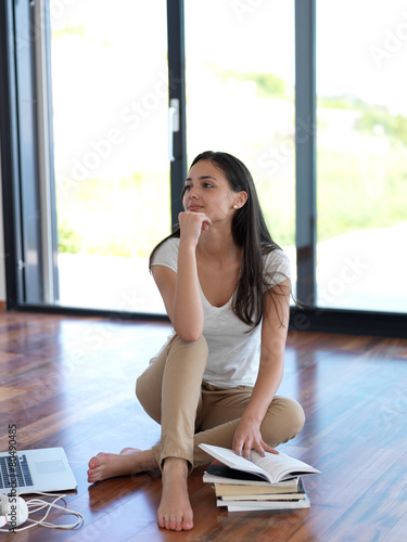relaxed young woman at home working on laptop computer