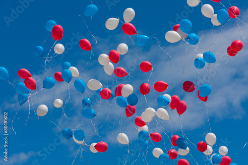 Colored balloons fly in the sky