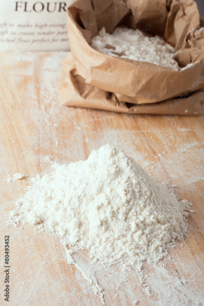 a small amount of flour on wooden board a small amount of flour on wooden board