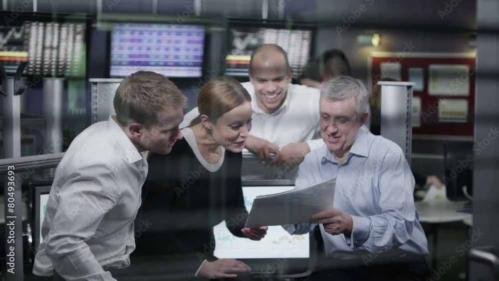 Casual team of financial traders taking a look at the figures