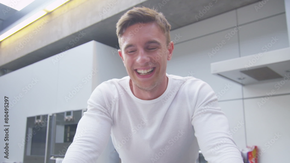 Happy attractive young man having a video chat from computer screen's pov