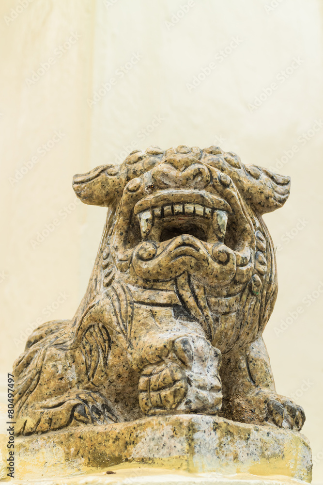 the ancient chinese lion statue under the sun light