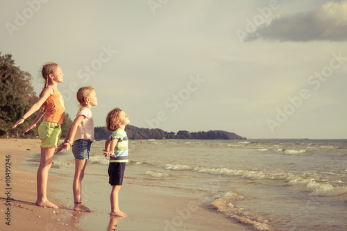 Happy children playing on the beach