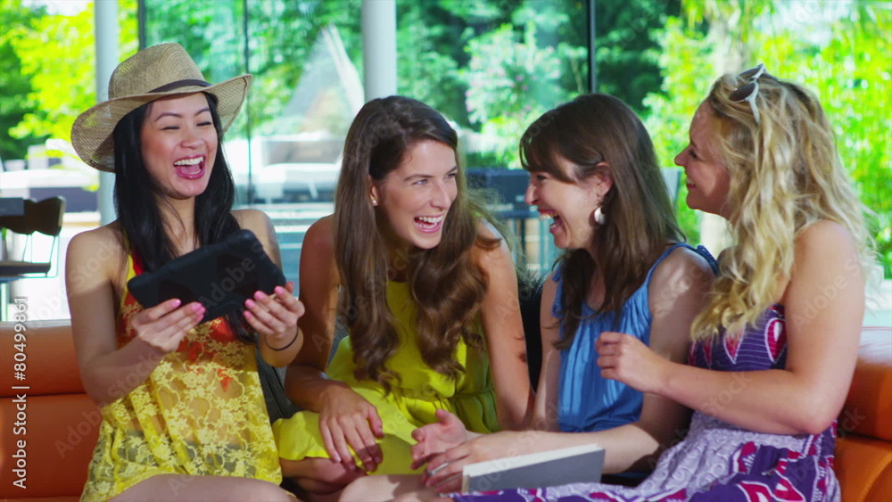 Happy group of friends posing & taking photos of themselves with tablet computer