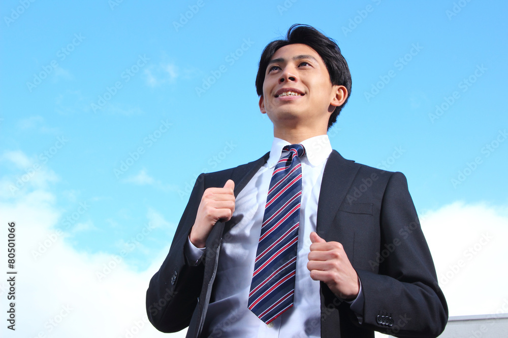 A businessman looking up at the sky A businessman looking up at the sky