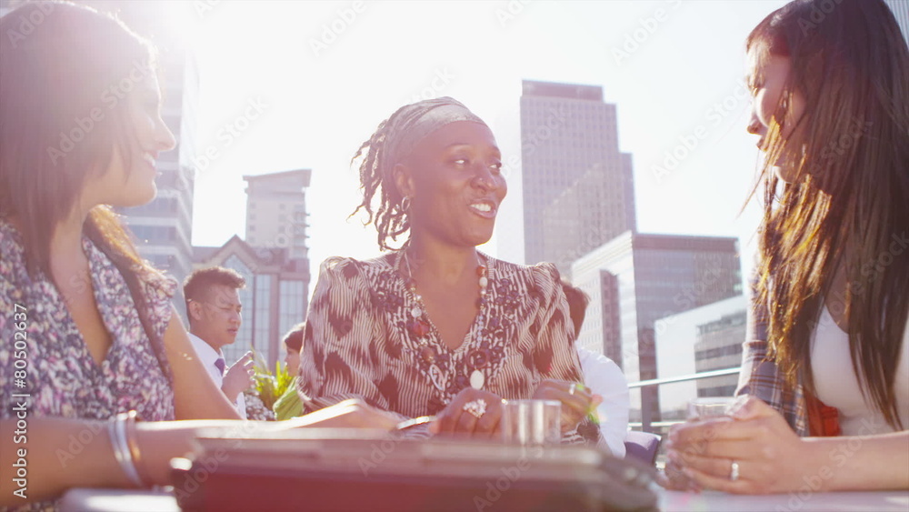Cheerful group of businesswomen in a meeting outdoors in the city on a sunny day Cheerful group of businesswomen in a meeting outdoors in the city on a sunny day