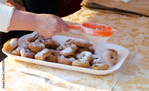 Elder Cook spread the icing sugar over cooked fritters