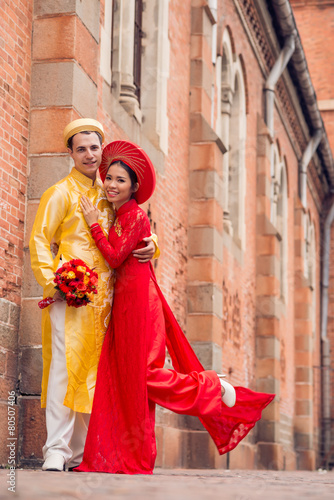 Newlywed couple in ao-dai dresses