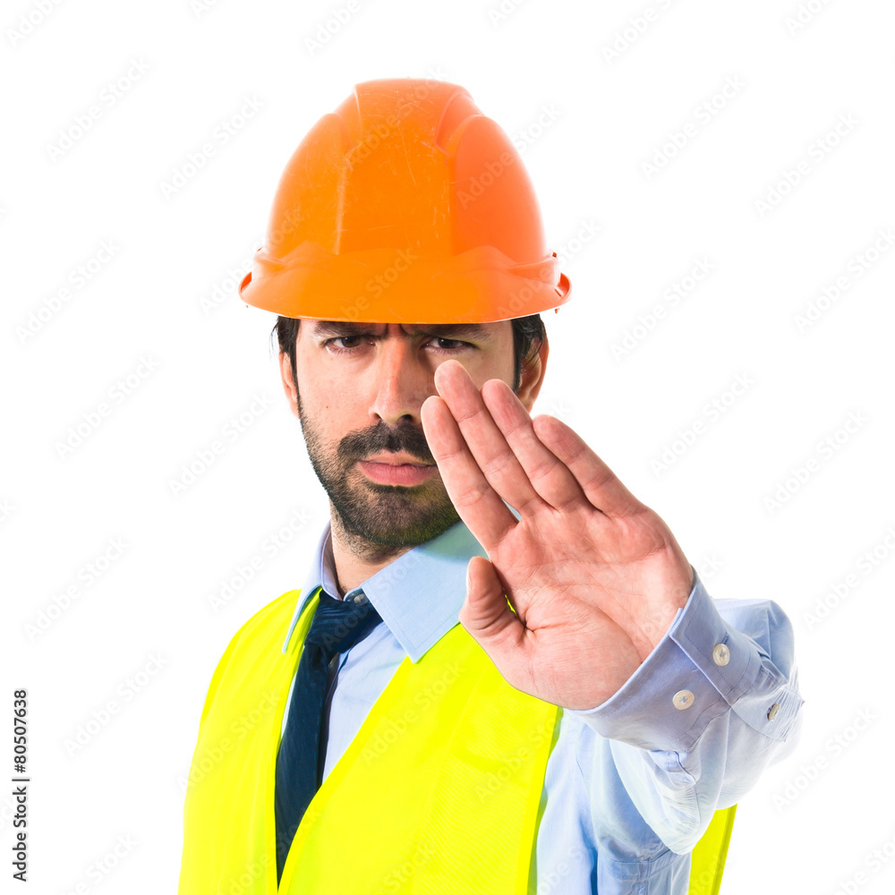 workman making stop sign over white background workman making stop sign over white background