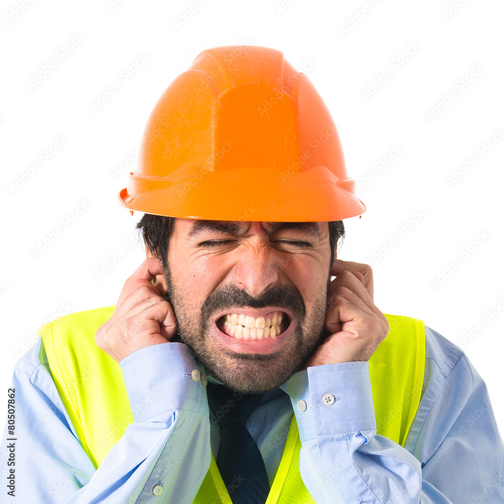 Workman covering his ears Workman covering his ears
