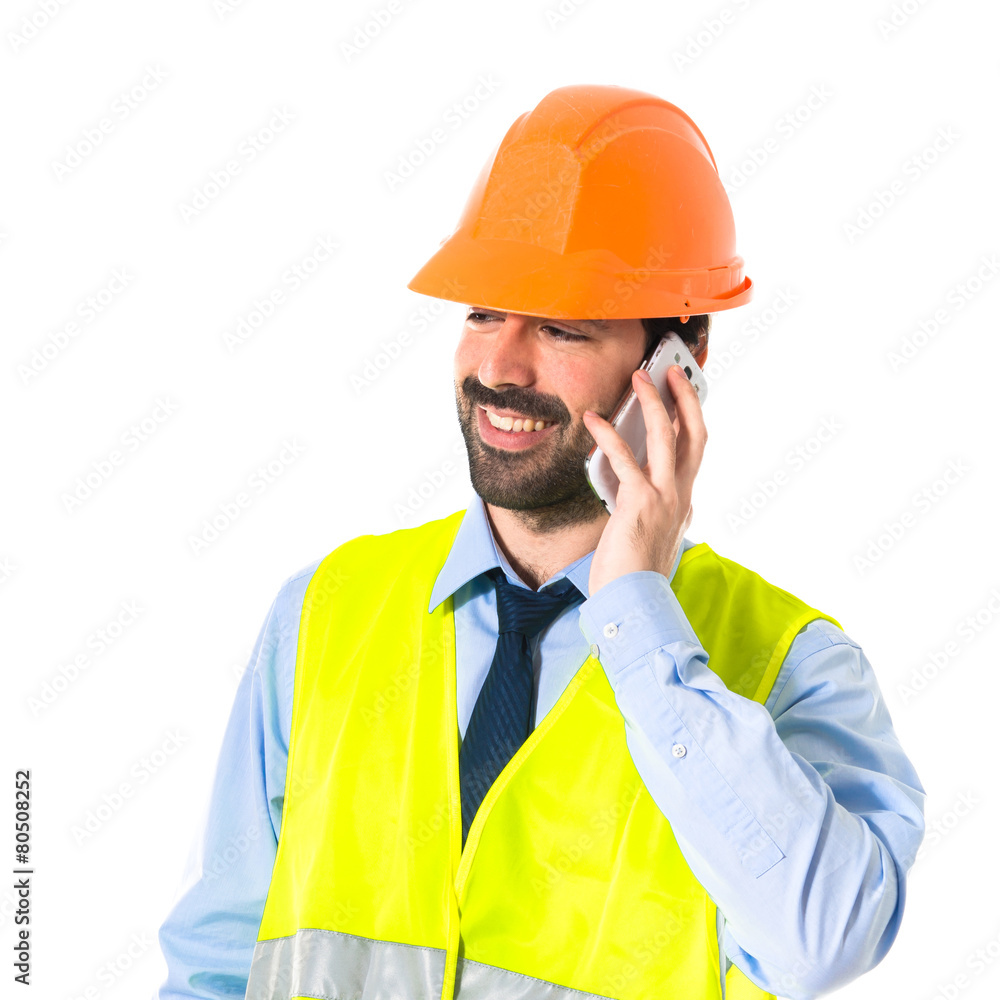Worker talking to mobile Worker talking to mobile