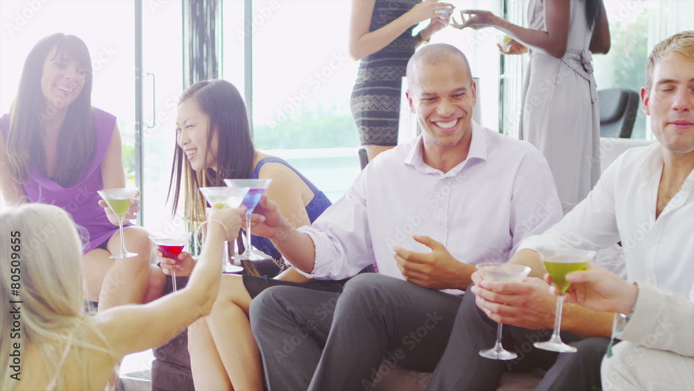 Portrait of attractive young mixed race man at a cocktail party with his friends