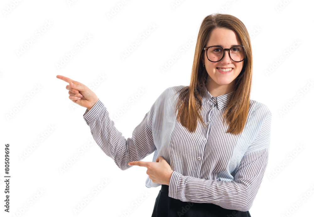 Teen girl pointing to the lateral Teen girl pointing to the lateral