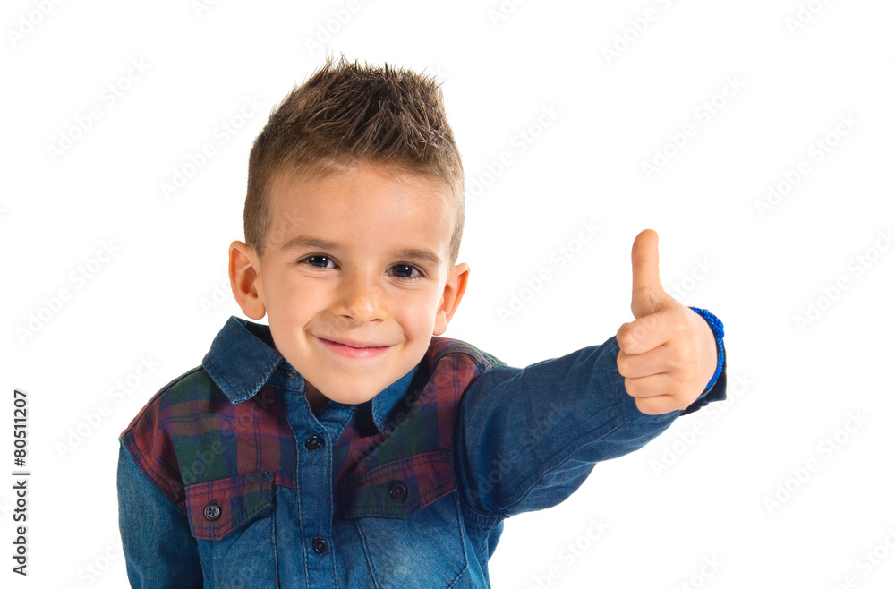 Kid with thumb up over white background Kid with thumb up over white background