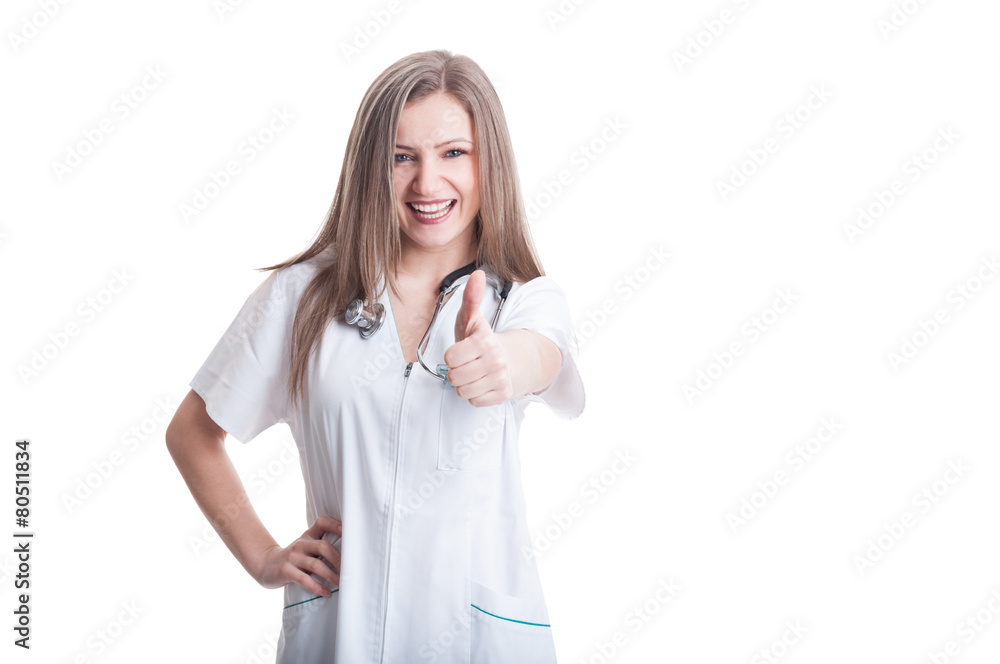 Young and beautiful female doctor showing thumbs up Young and beautiful female doctor showing thumbs up