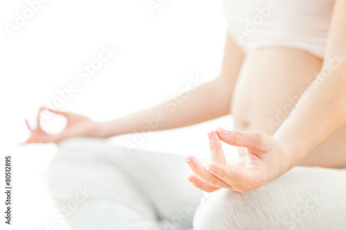 Pregnant woman sitting and meditating