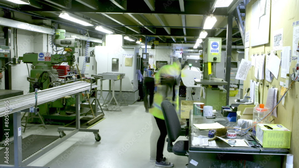 Time lapse of busy workers in the office section of a warehouse or factory Time lapse of busy workers in the office section of a warehouse or factory