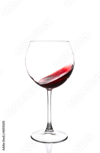 red wine swirling in a goblet wine glass,
