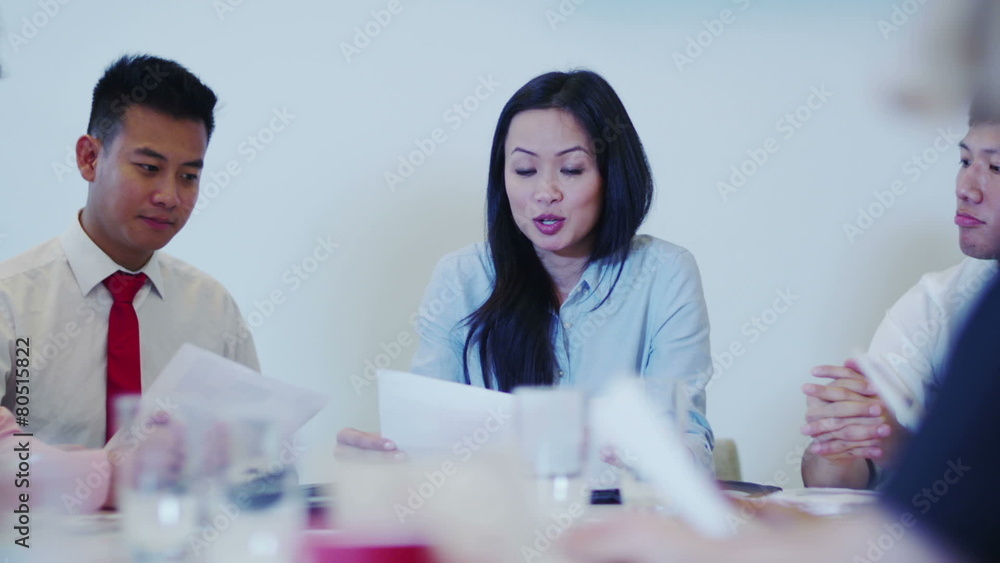 Attractive young mixed ethnicity business team in a boardroom meeting. Attractive young mixed ethnicity business team in a boardroom meeting.