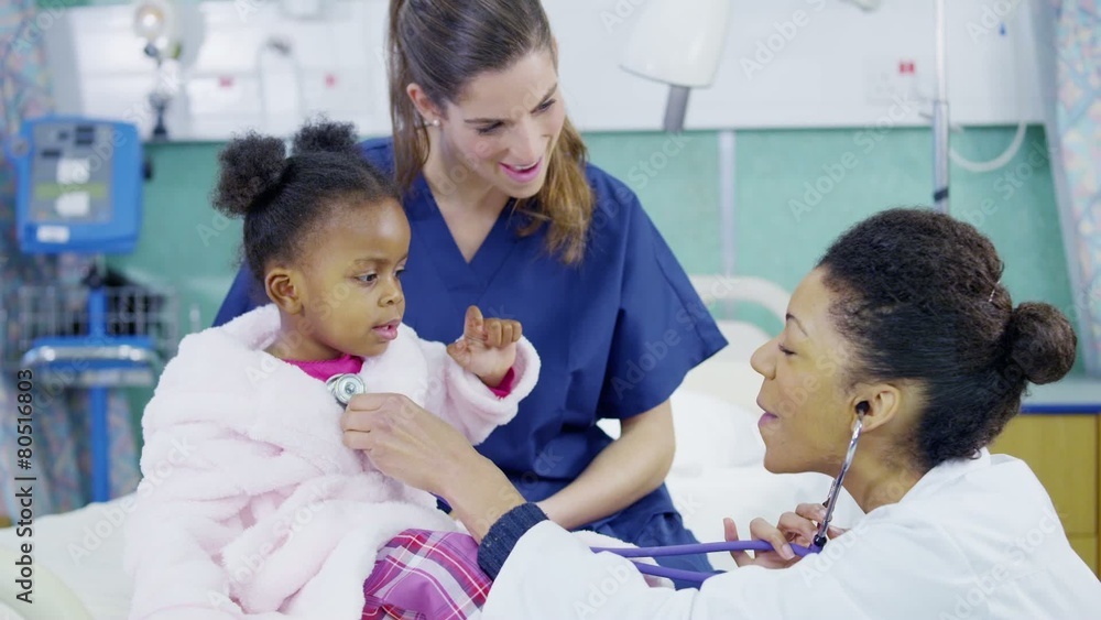 Female doctor uses a stethoscope to examine cute little girl in hospital. Female doctor uses a stethoscope to examine cute little girl in hospital.