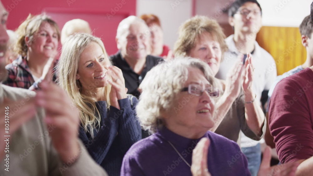 Mature male speaker addresses public meeting or church group