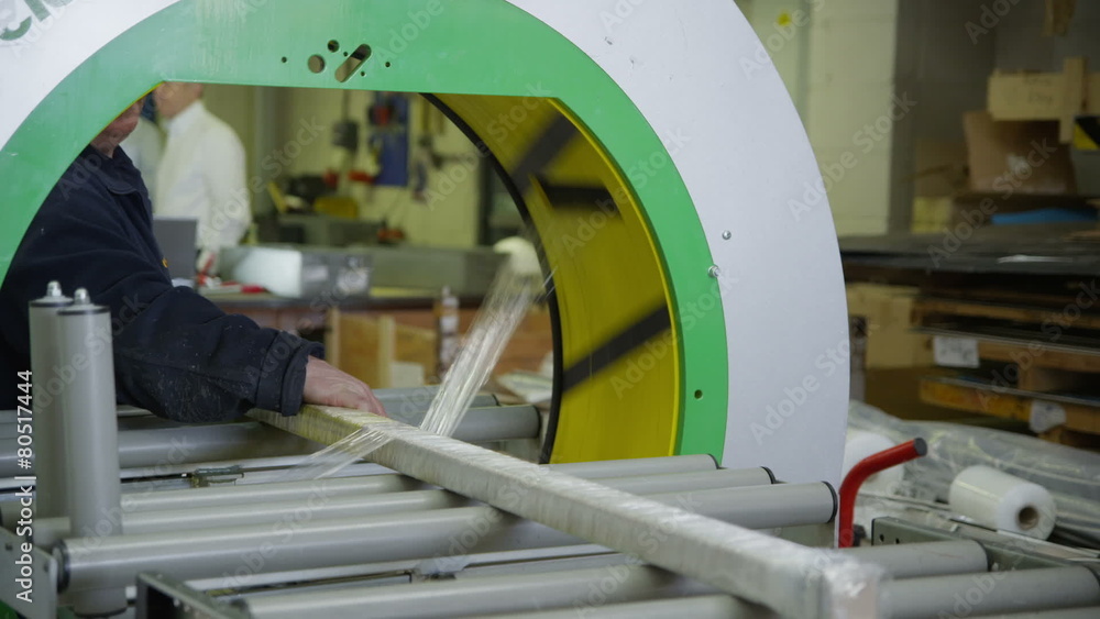 Operator using a packaging machine to prepare goods for delivery Operator using a packaging machine to prepare goods for delivery