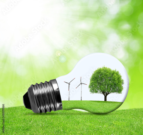 Eco bulb with wind turbines and tree. Green energy concept.