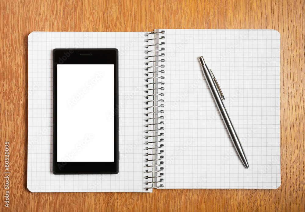 Business and education concept - smartphone and notepad Business and education concept - smartphone and notepad