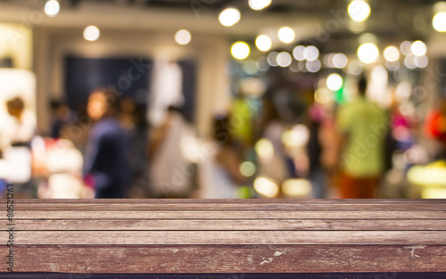 Empty wood table top with restaurant blur with bokeh