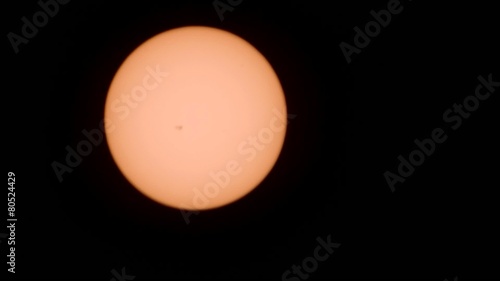 Sun through telescope. With sunspots and atmosphere distortion. photo