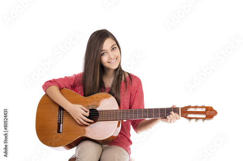 Obraz na płótnie Pretty teenage girl playing an acoustic guitar w salonie