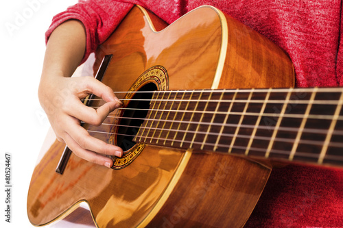 Closeup of girl hands playing guitar