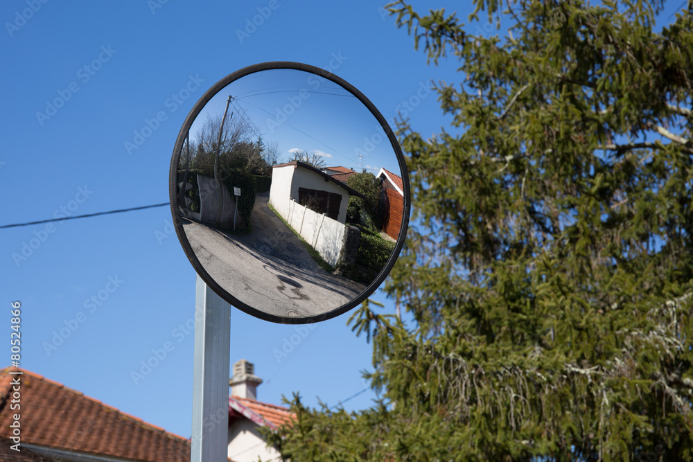 Close up traffic convex mirror near car park entrance Close up traffic convex mirror near car park entrance