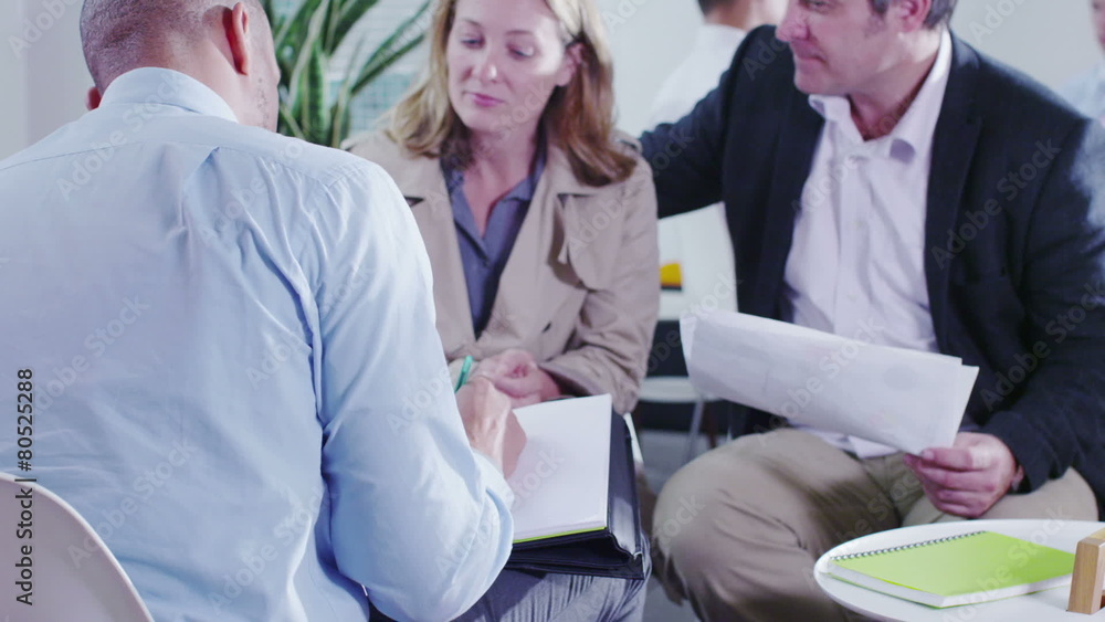 Couple in a meeting with their bank manager or financial advisor Couple in a meeting with their bank manager or financial advisor